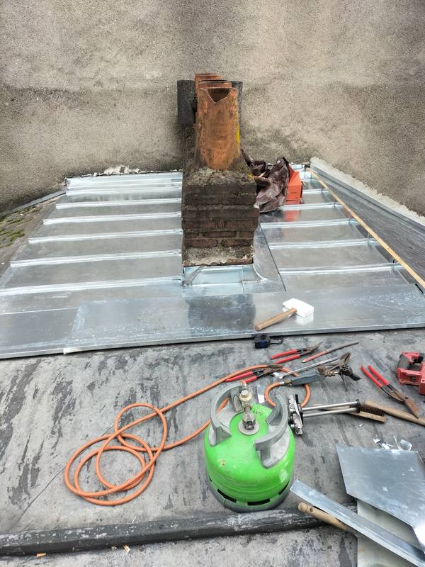 Pose des feuilles de zinc, matériel de soudure sur le toit